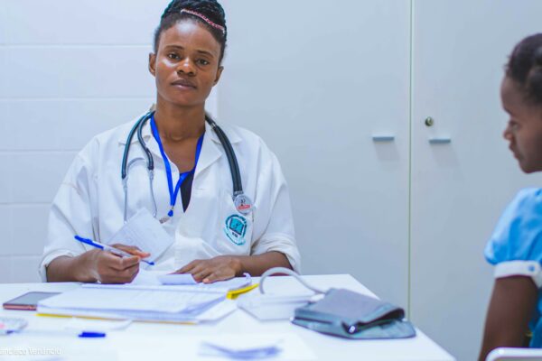 doctor sitting at the table in front of girl