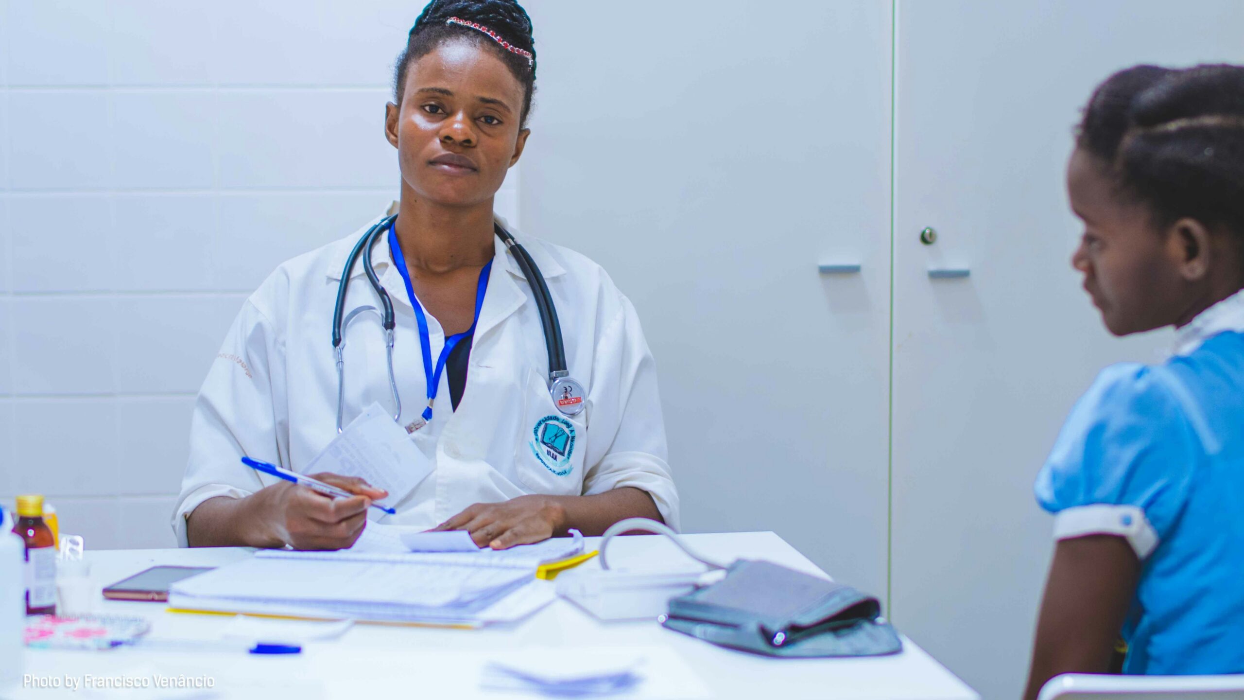 doctor sitting at the table in front of girl