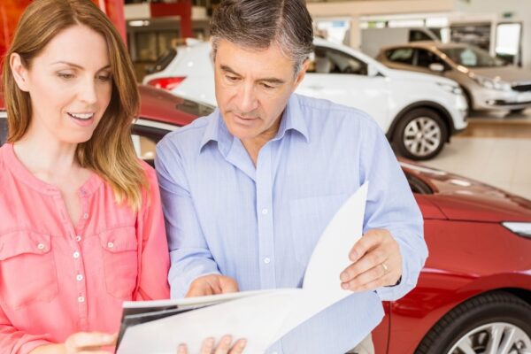 Smiling couple choosing the color of their new car