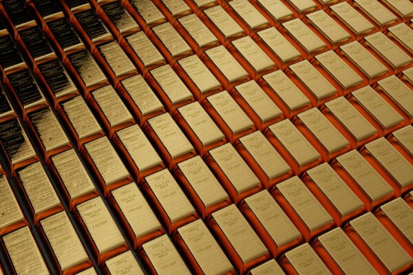 a large amount of gold bars stacked on top of each other