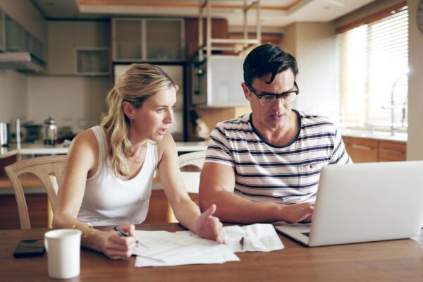 Finance problem and couple with laptop with bills stress and internet banking issue in debt Home payment due and anxiety from mortgage tax audit or invoice with conversation about savings