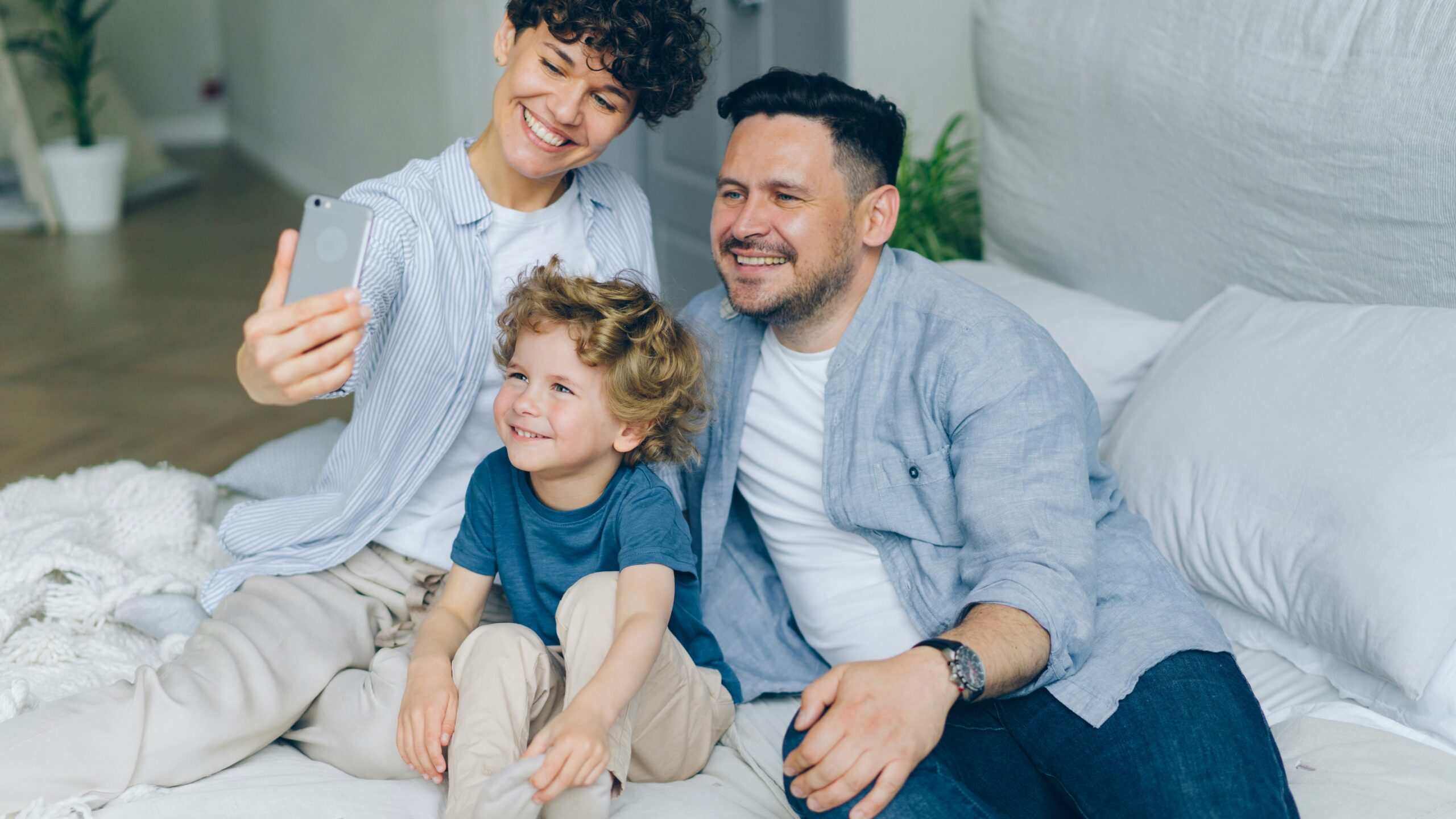 a man and two children sitting on a bed