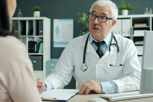 Doctor talking to patient in an office