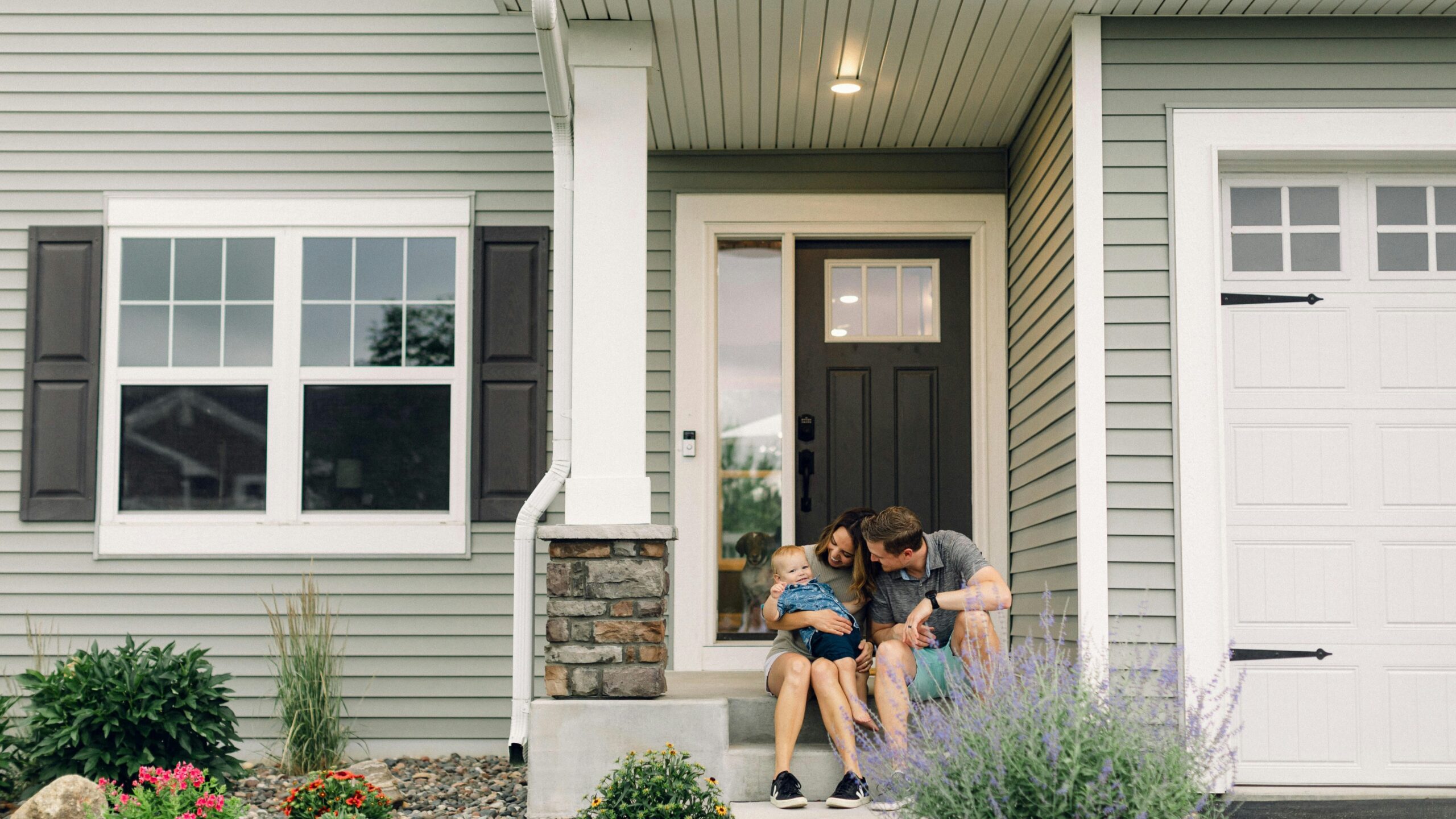 a couple of people that are sitting in front of a house
