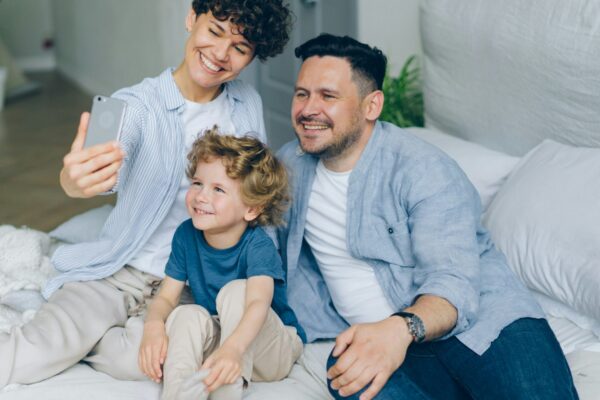 a man and two children sitting on a bed