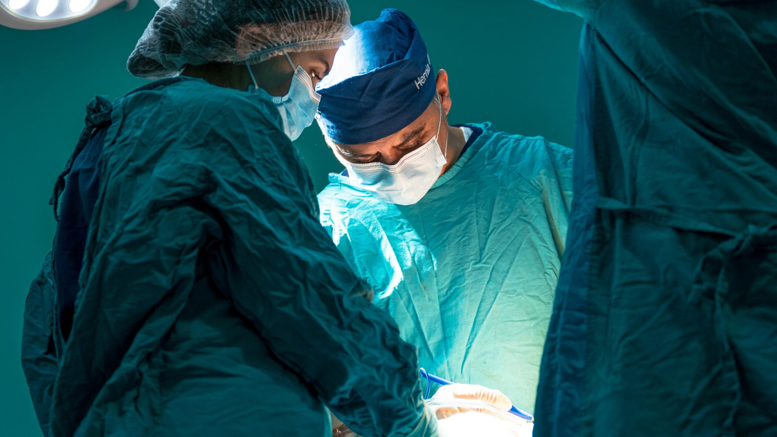 a group of doctors performing surgery on a patient