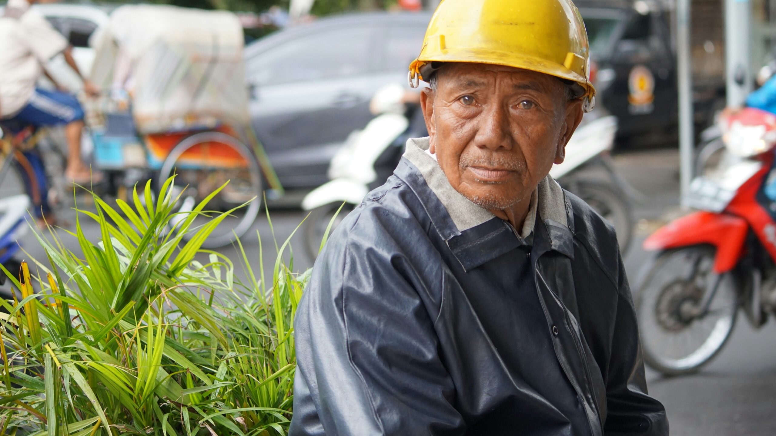 man in black jacket wearing yellow hard hat