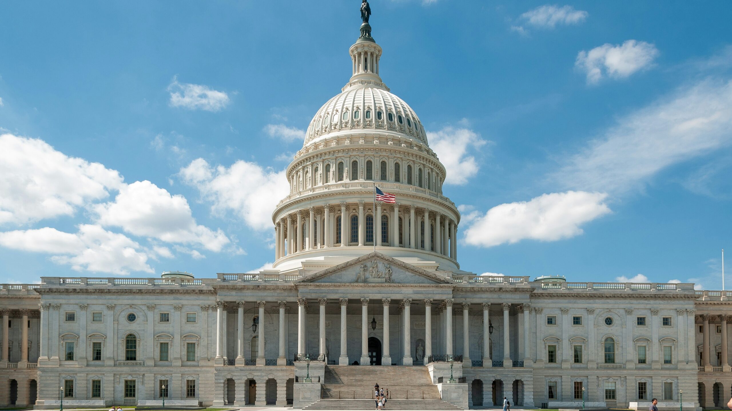 a large white building with a flag on top of it