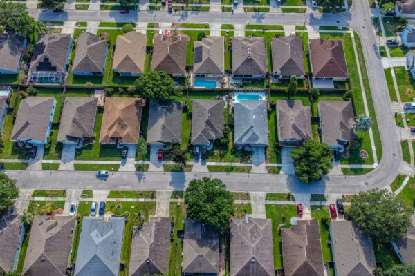 Residential neighborhood with houses, streets, and a backyard swimming pool