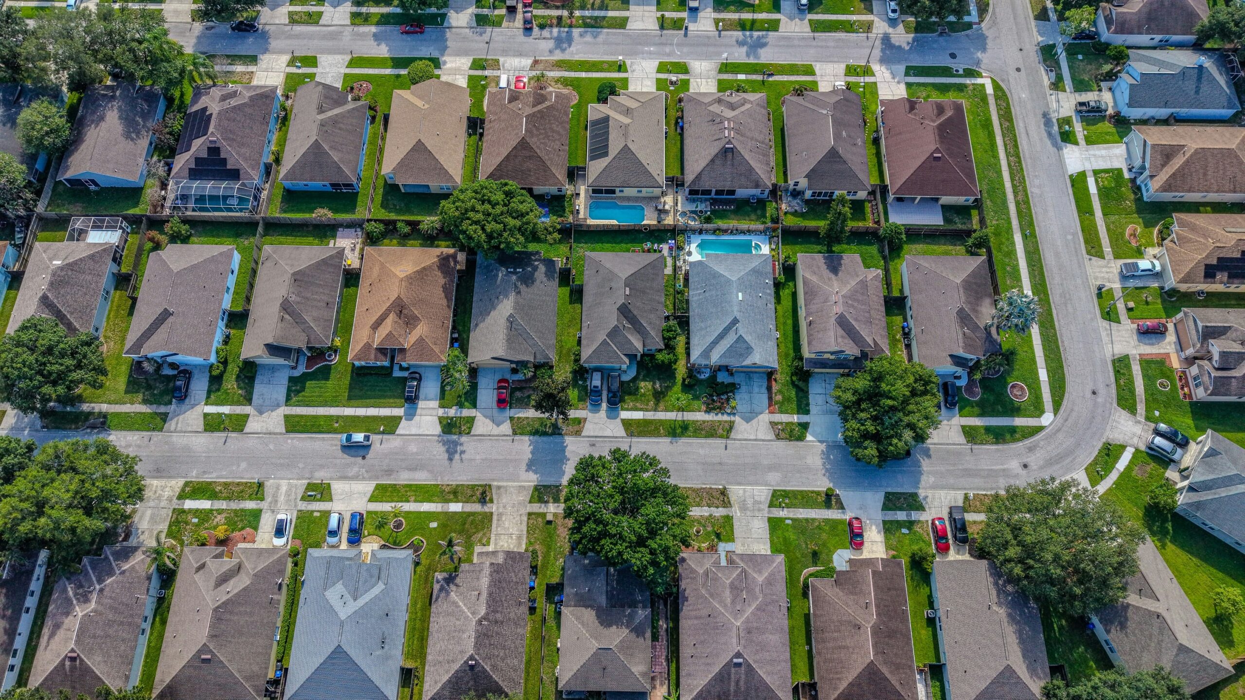 Residential neighborhood with houses, streets, and a backyard swimming pool