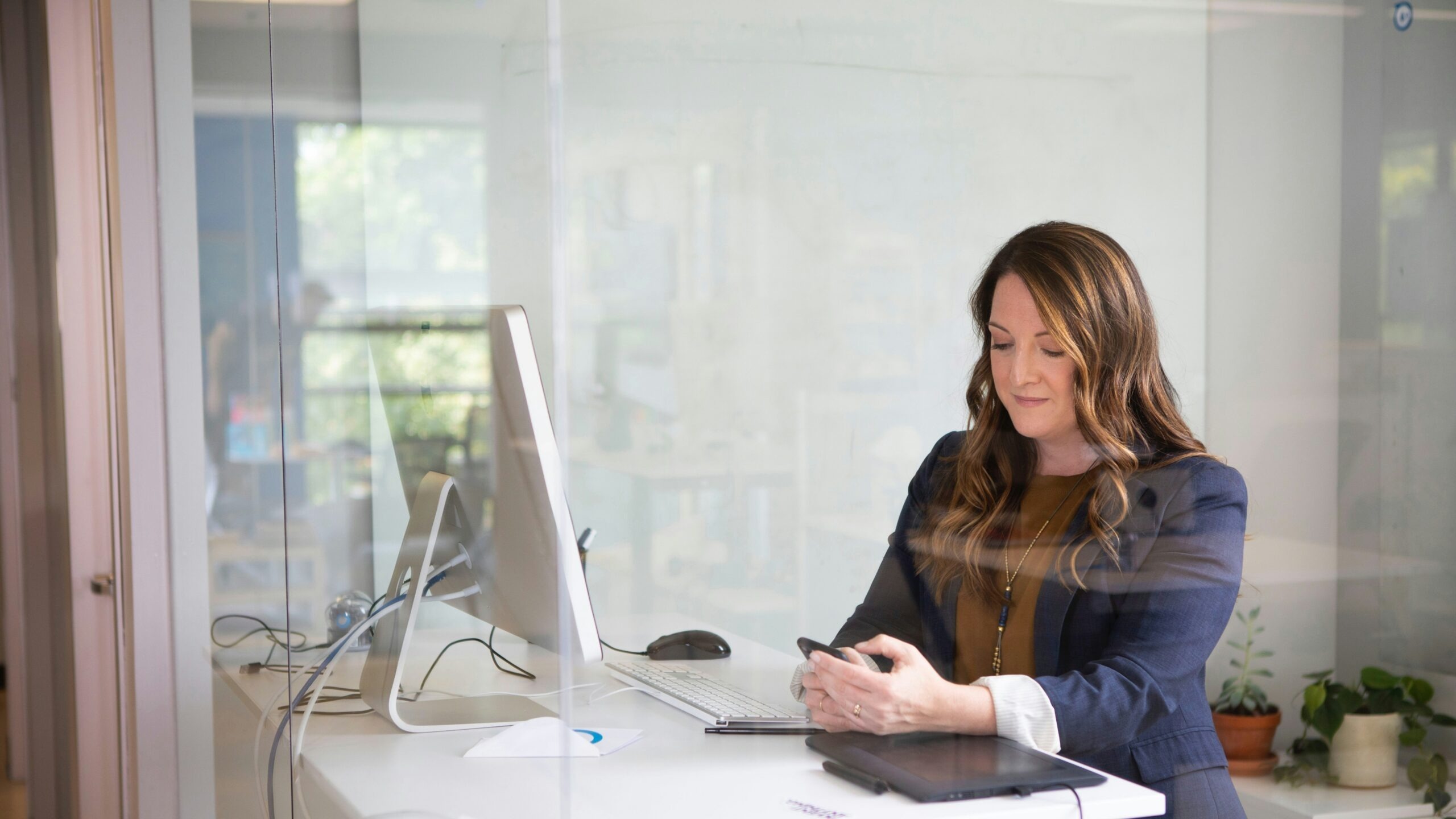 woman in black leather jacket using macbook air