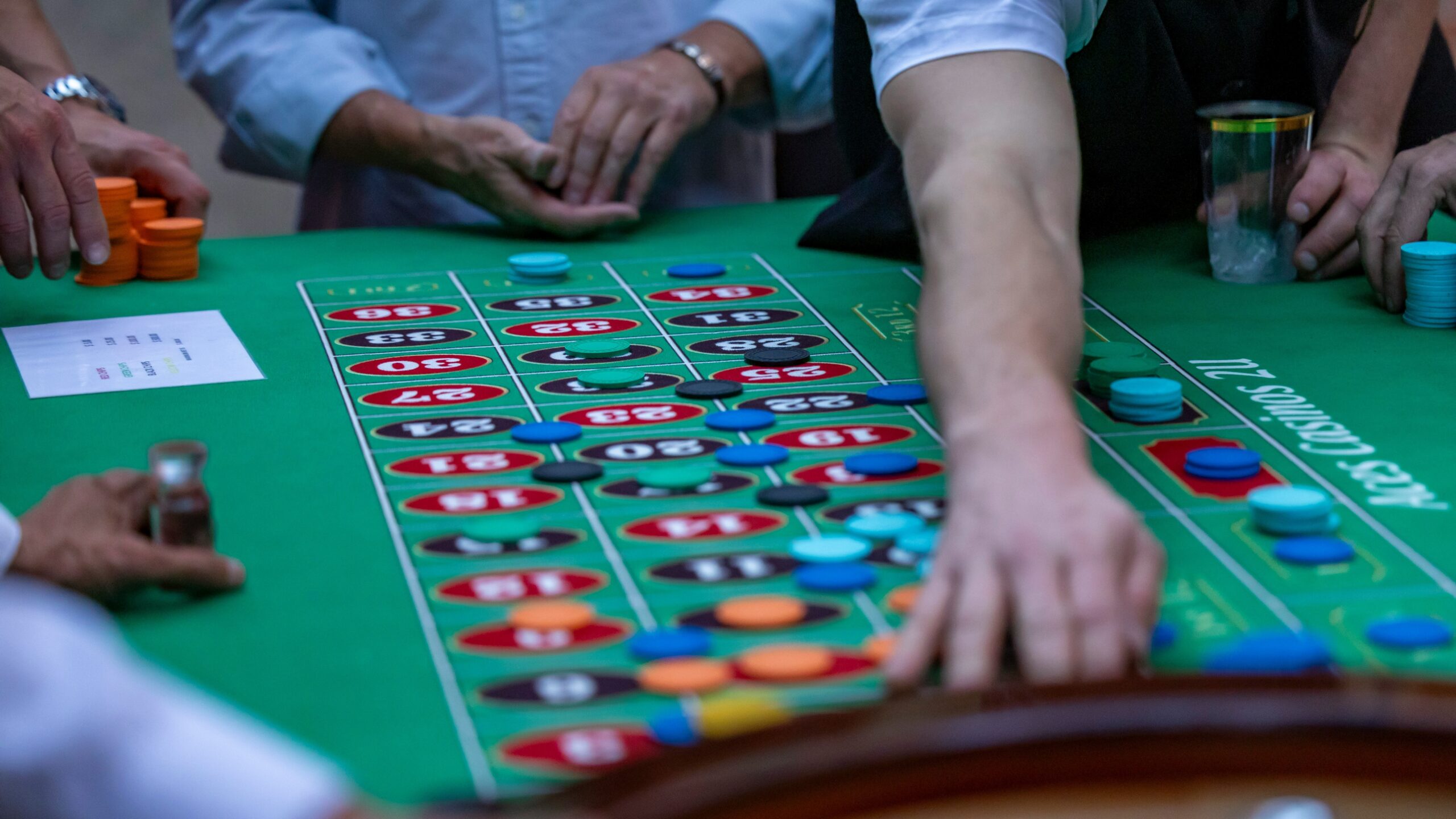 a group of people playing a game of crap at a casino