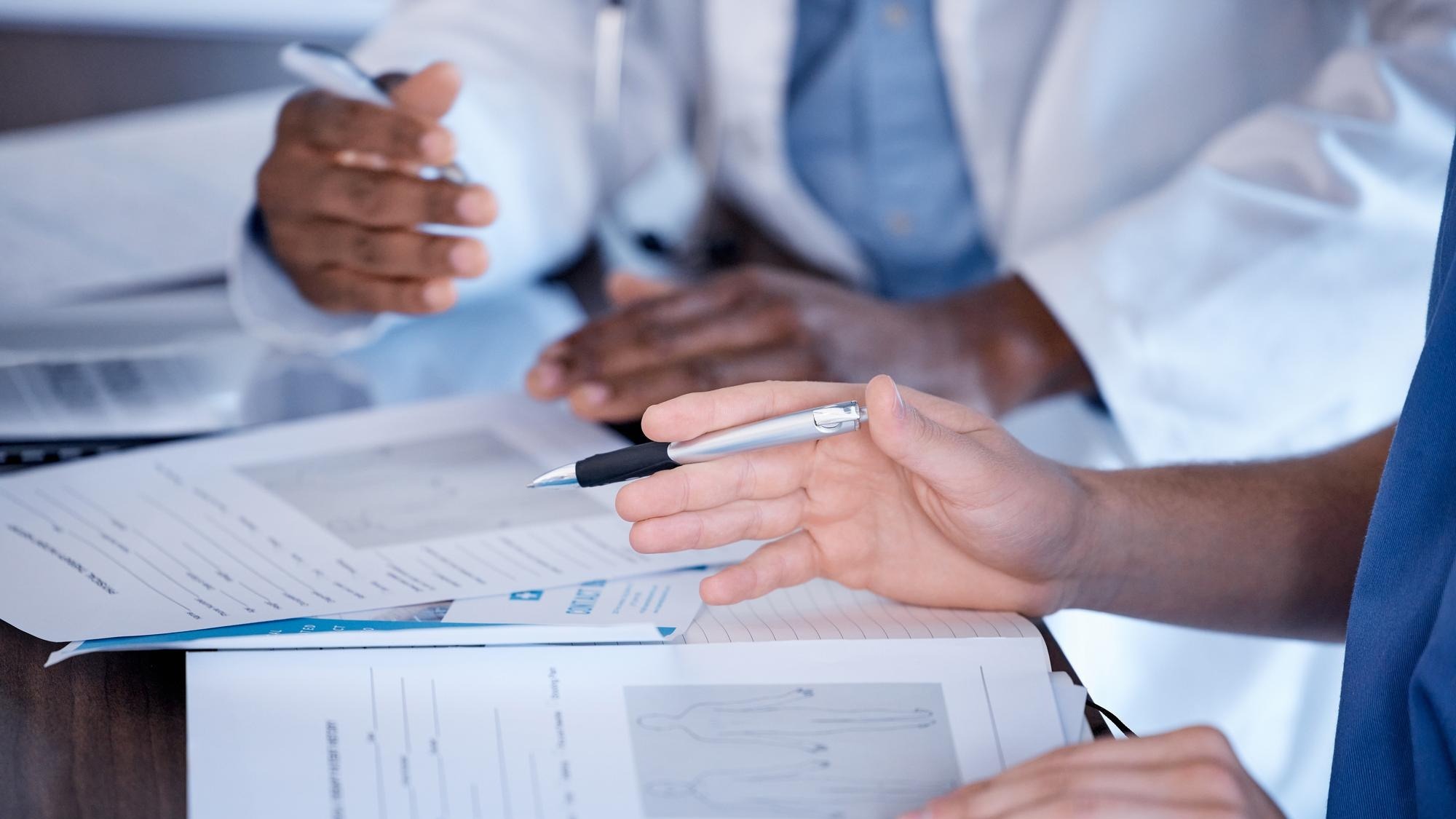 Doctors hands and paperwork of people for research healthcare planning and analysis Hospital staff medical documents and consulting in clinic team and expert advice of decision making results