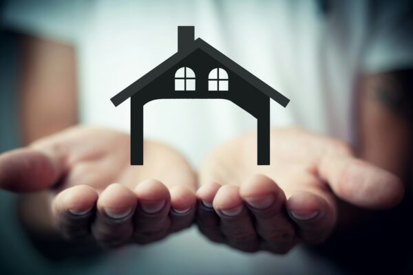 Hands holding a silhouette of a house