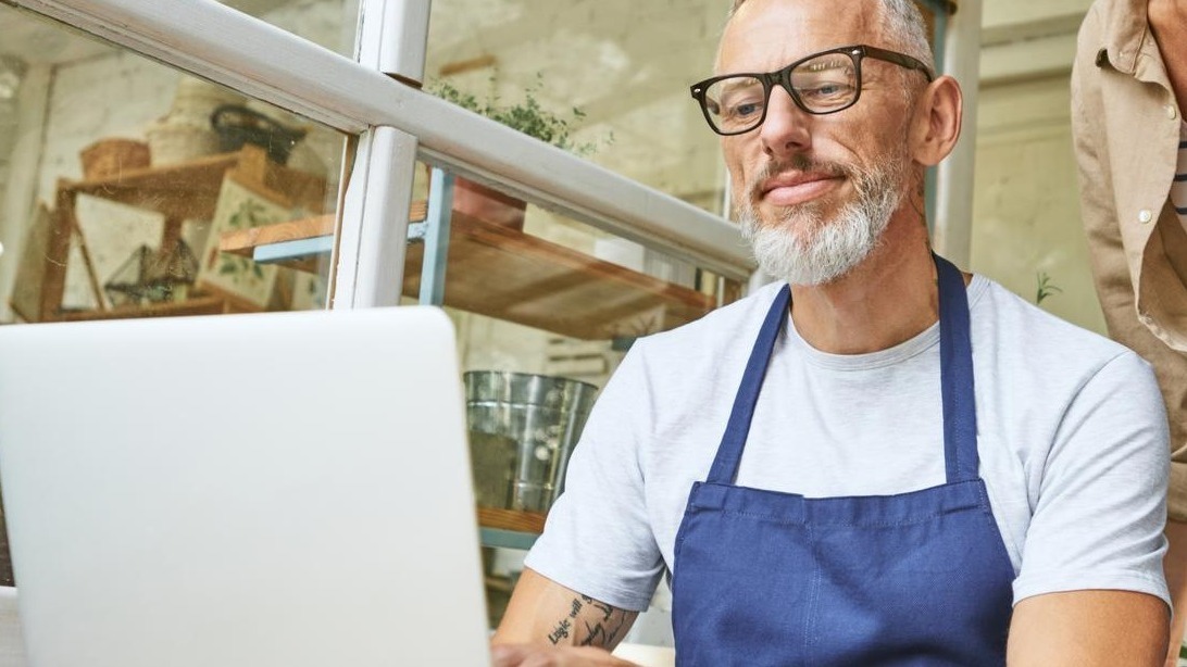 Middle aged caucasian business partners working on laptop