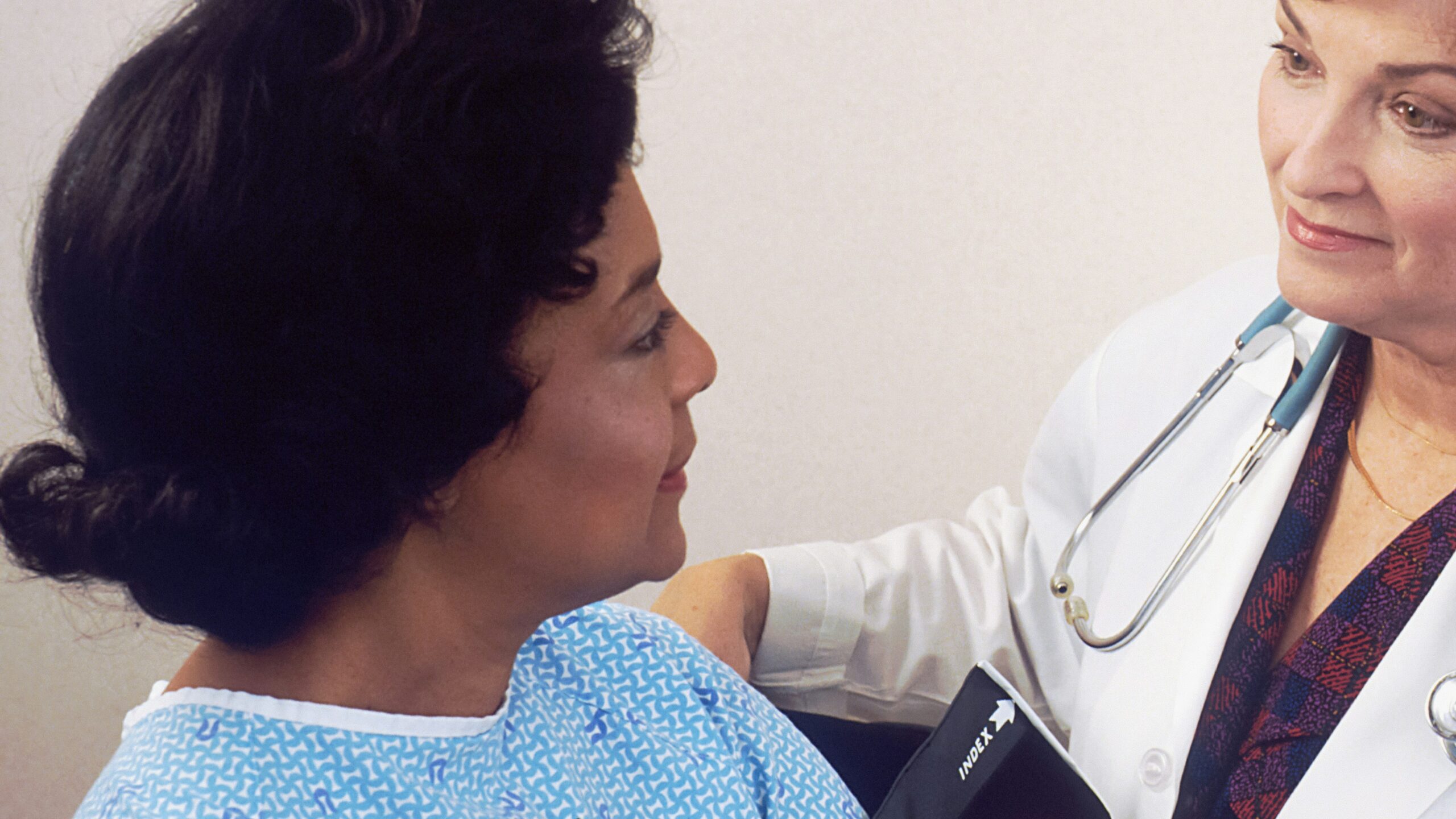 a woman with a stethoscope talking to another woman