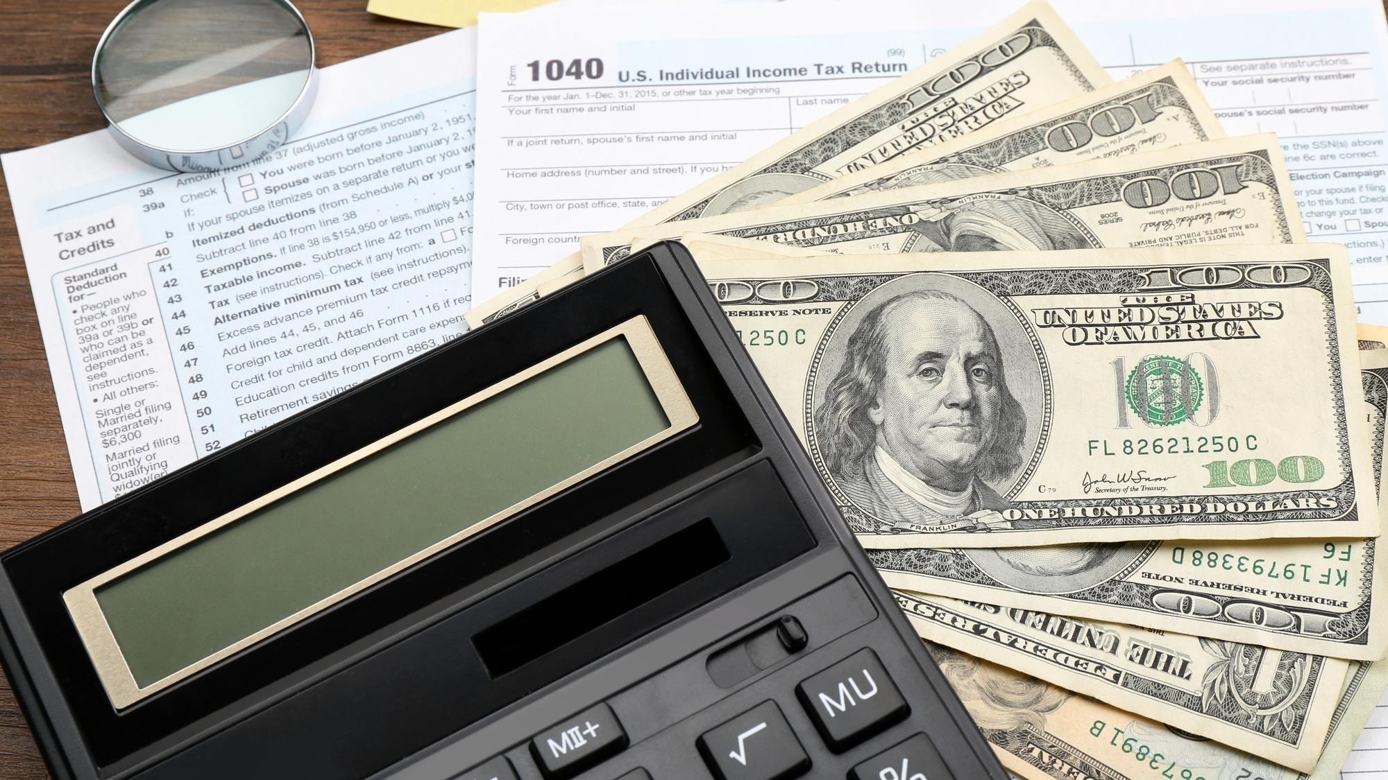 Calculator with money and documents closeup Tax concept