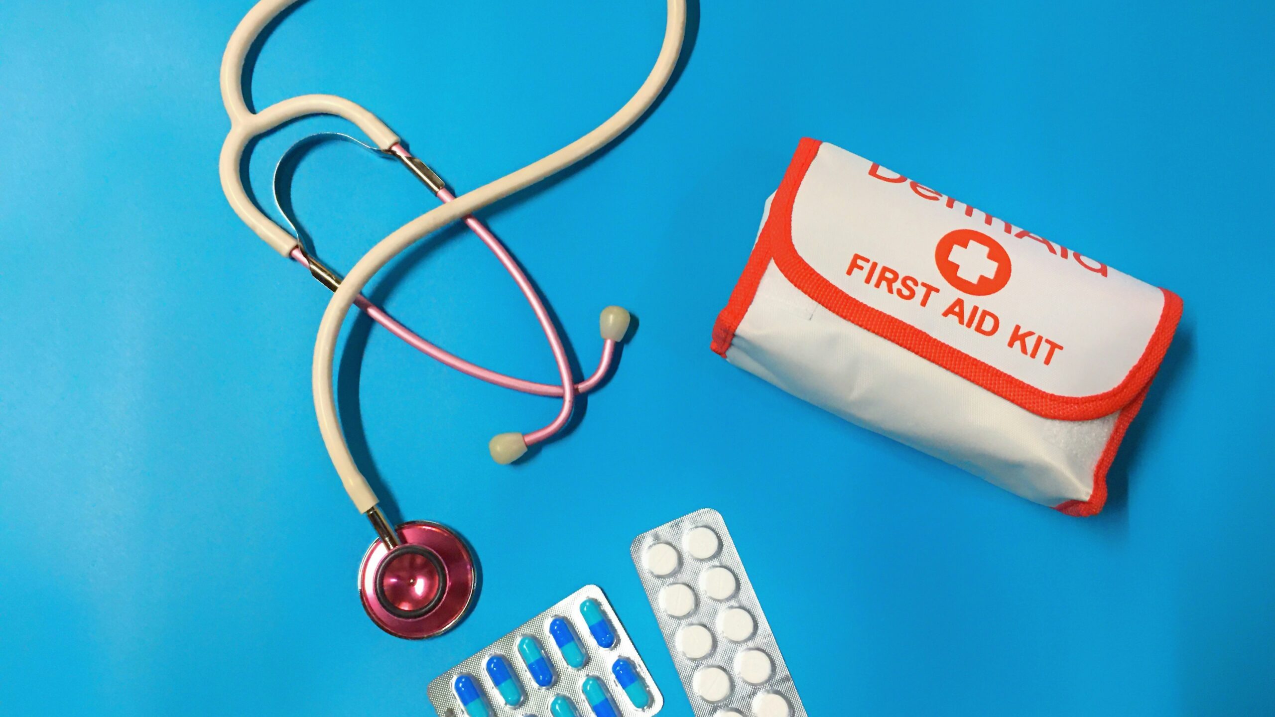 a bag of pills, a stethoscope, and a first aid kit