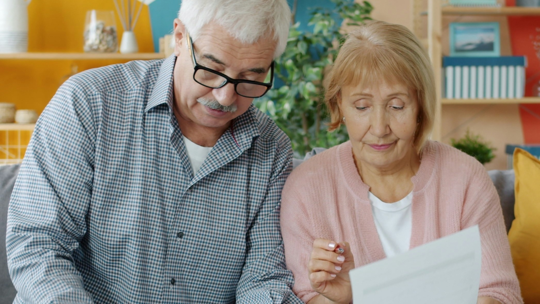 Elderly couple reviewing documents at home