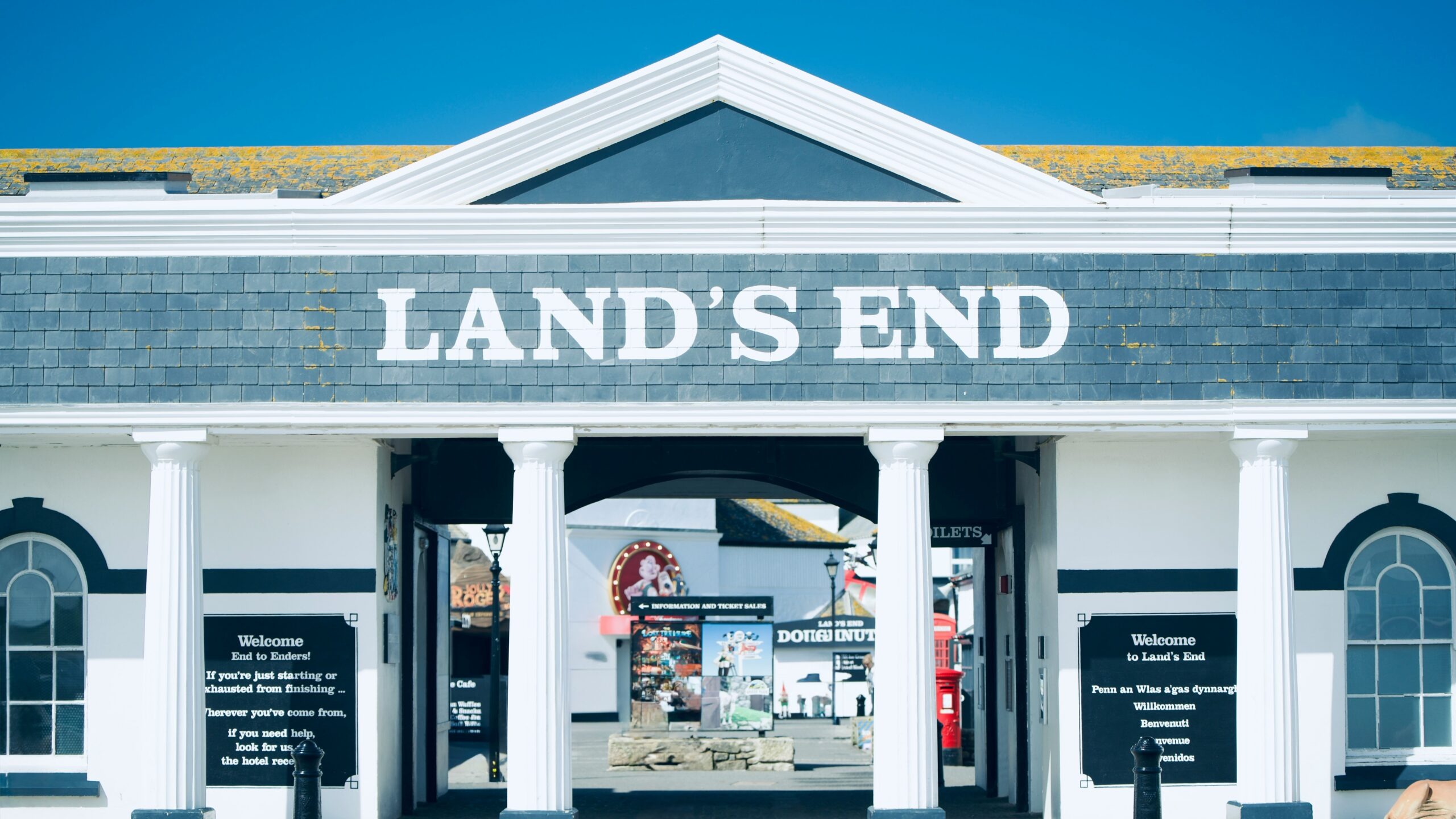 Land's end entrance displays white pillars and signage.