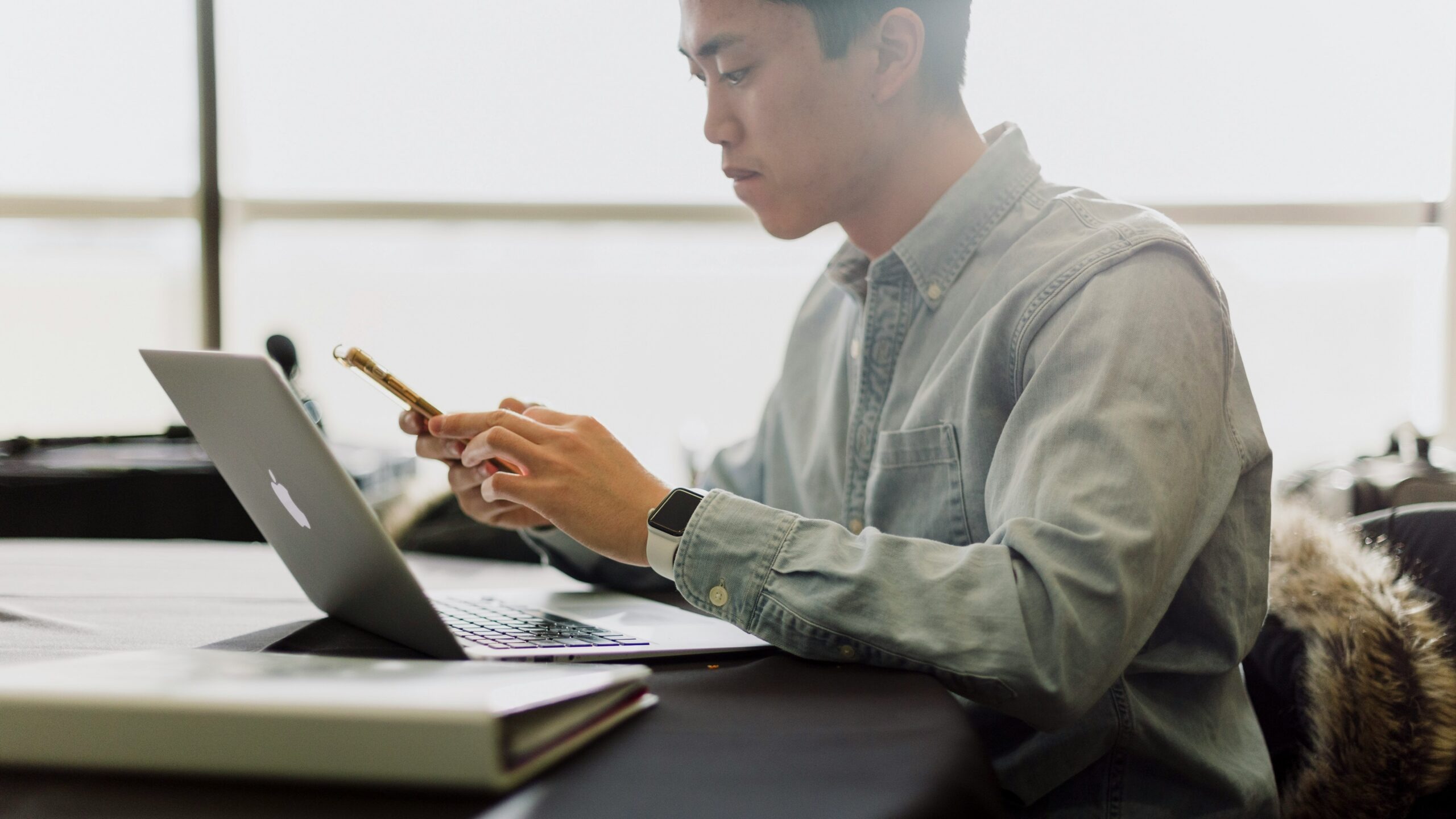a man sitting in front of a laptop computer