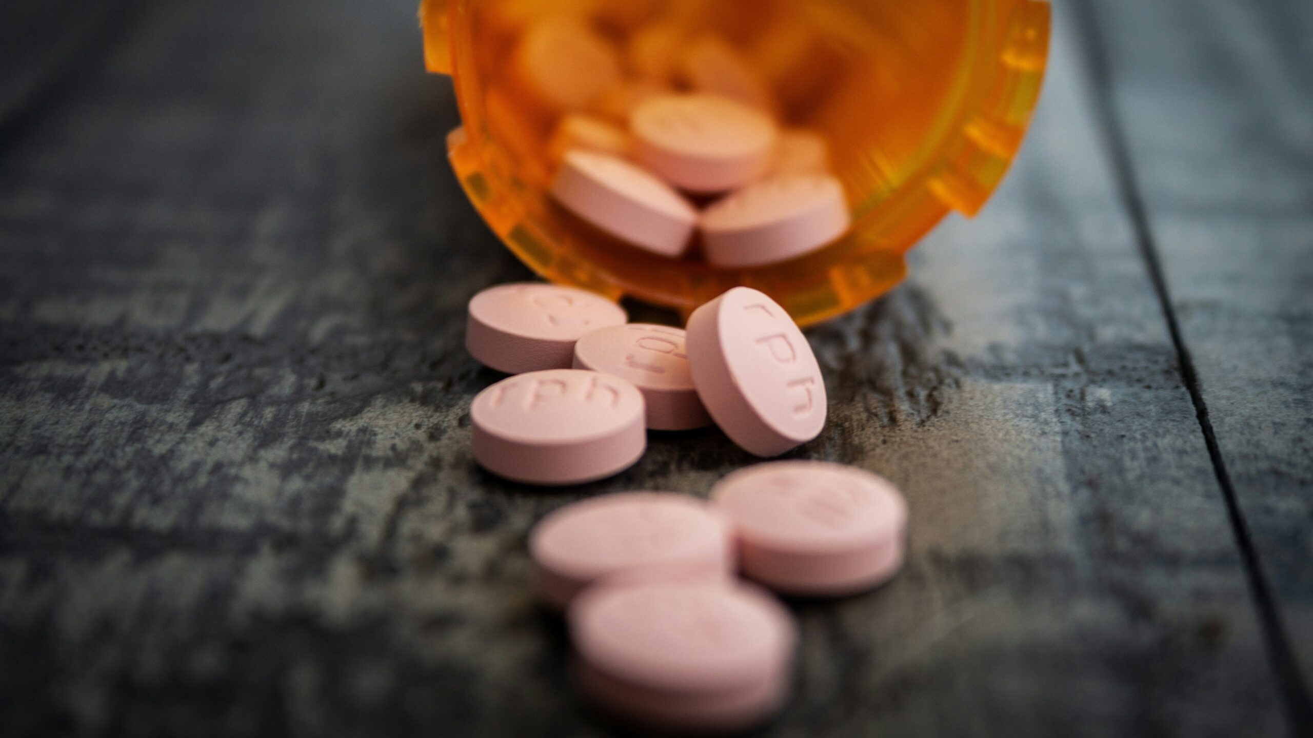 white medication pill on orange plastic container