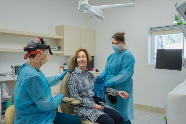 A group of people in a dental room