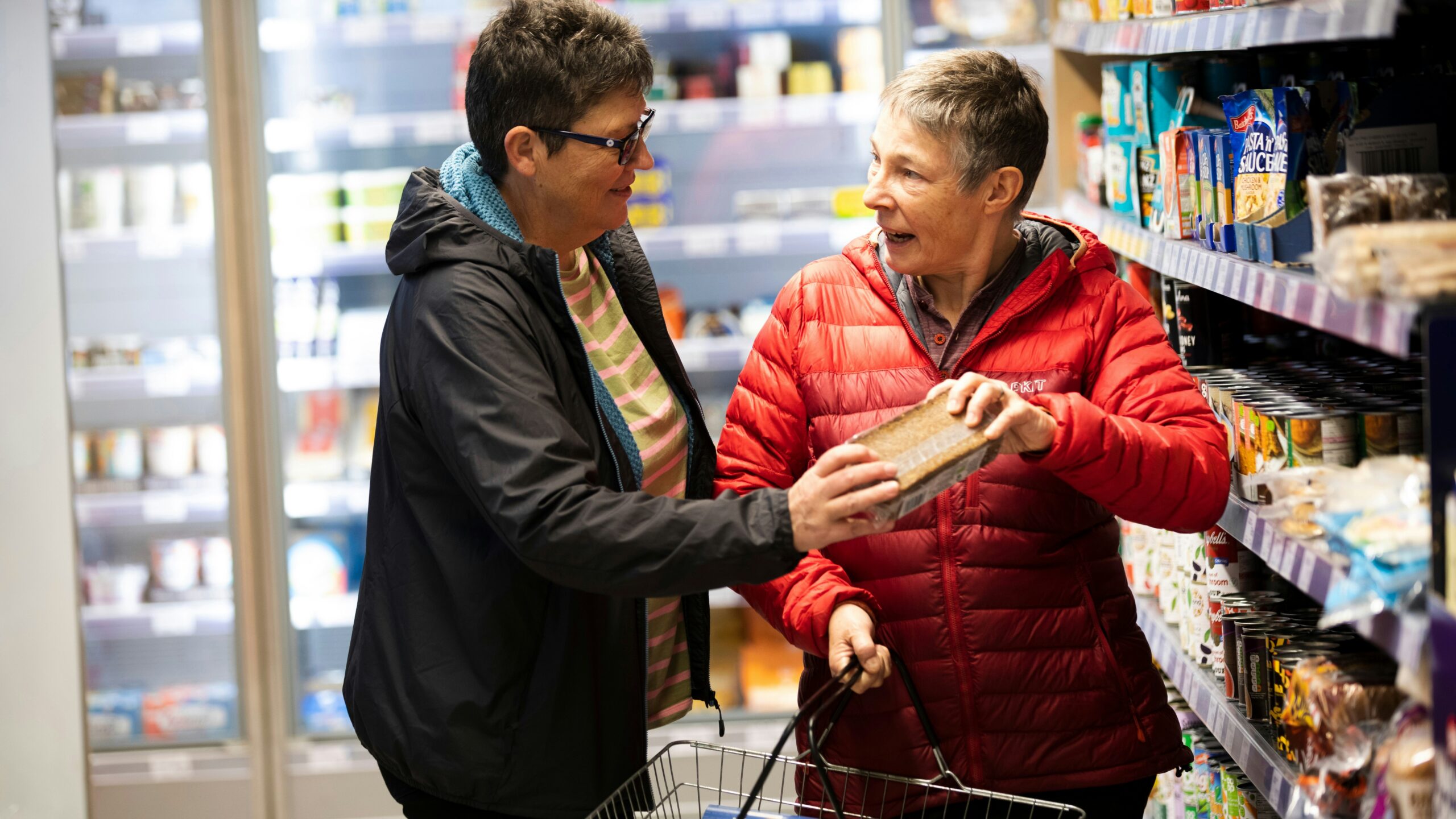 a man and a woman shopping in a grocery store