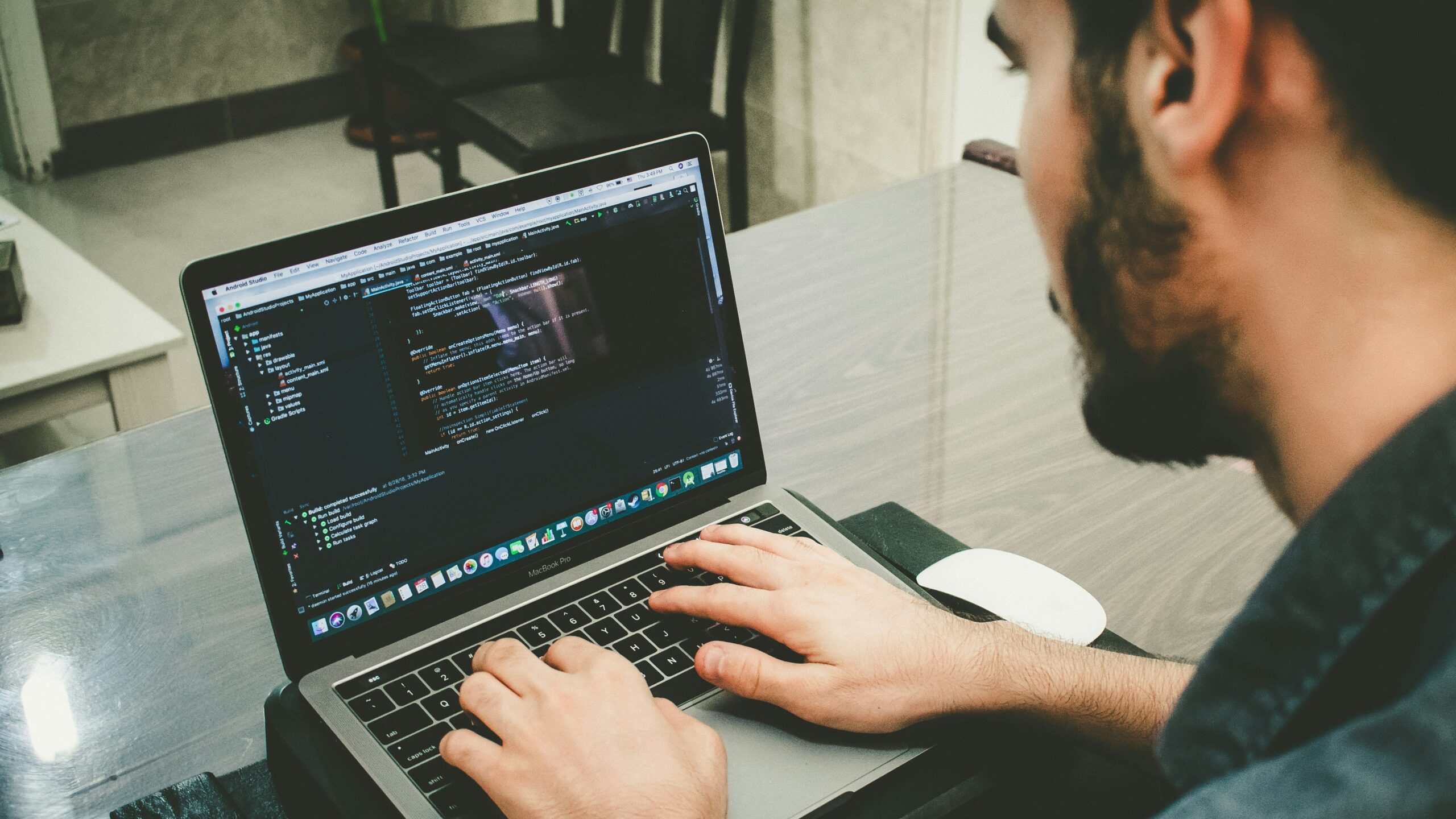 man programming using laptop