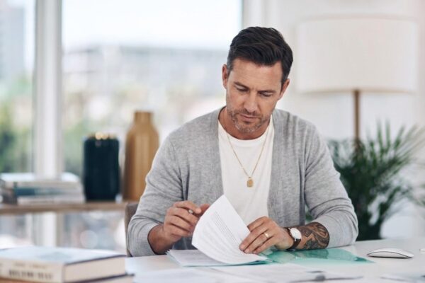 Files reading and woman in office with paperwork administration and checking research report Planning service and consultant at desk with insurance application registration folder or documents