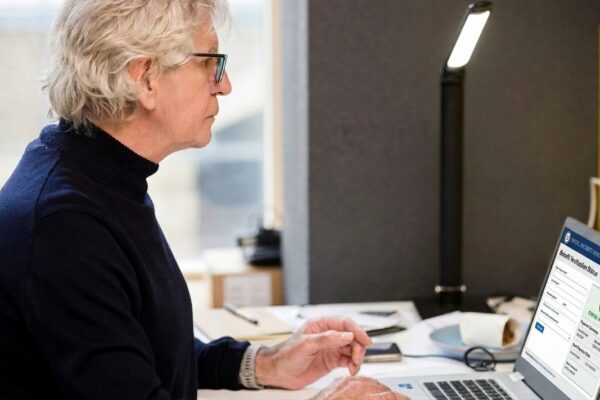 a woman sitting in front of a laptop computer