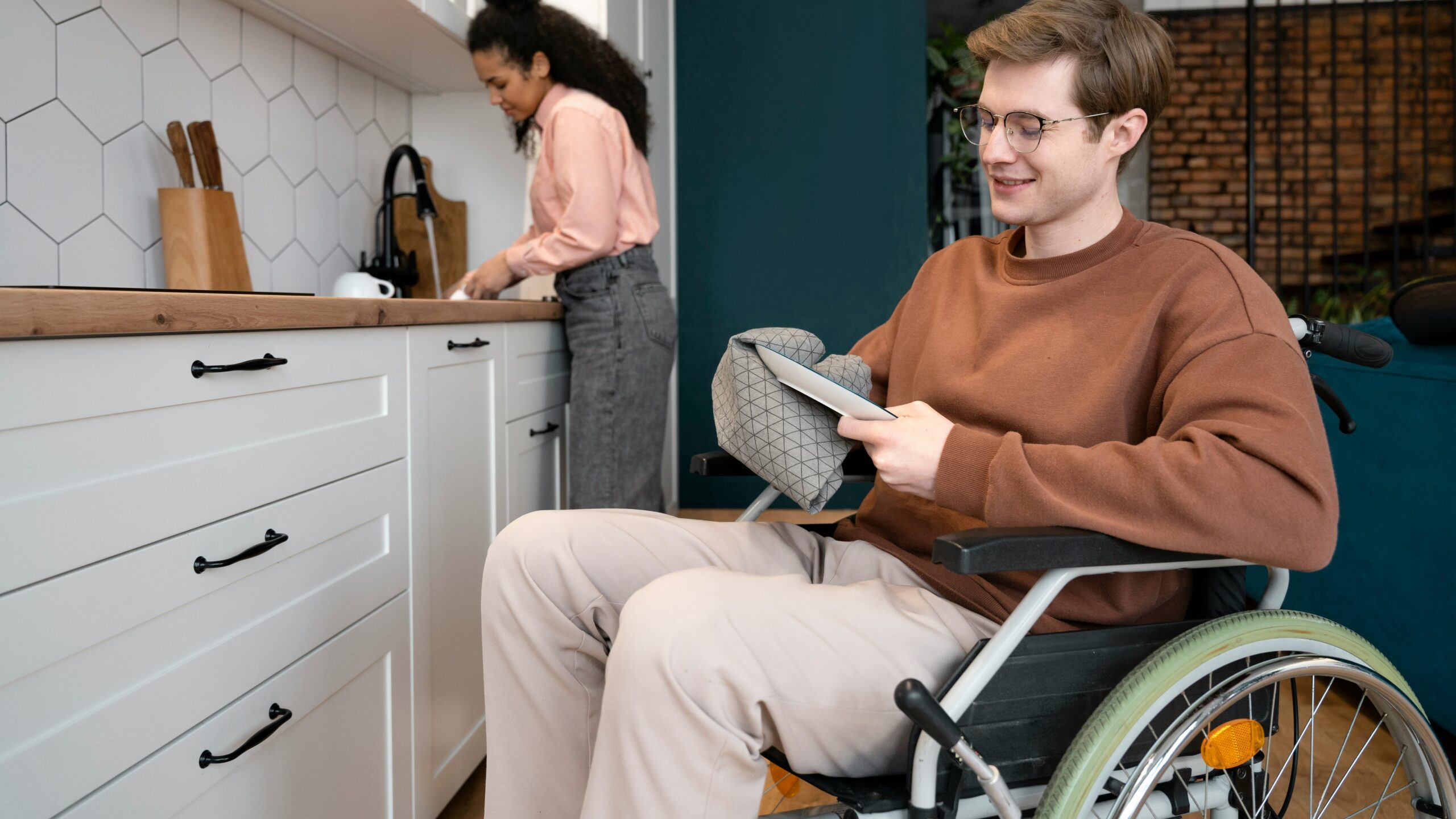 A man in a wheel chair in a kitchen