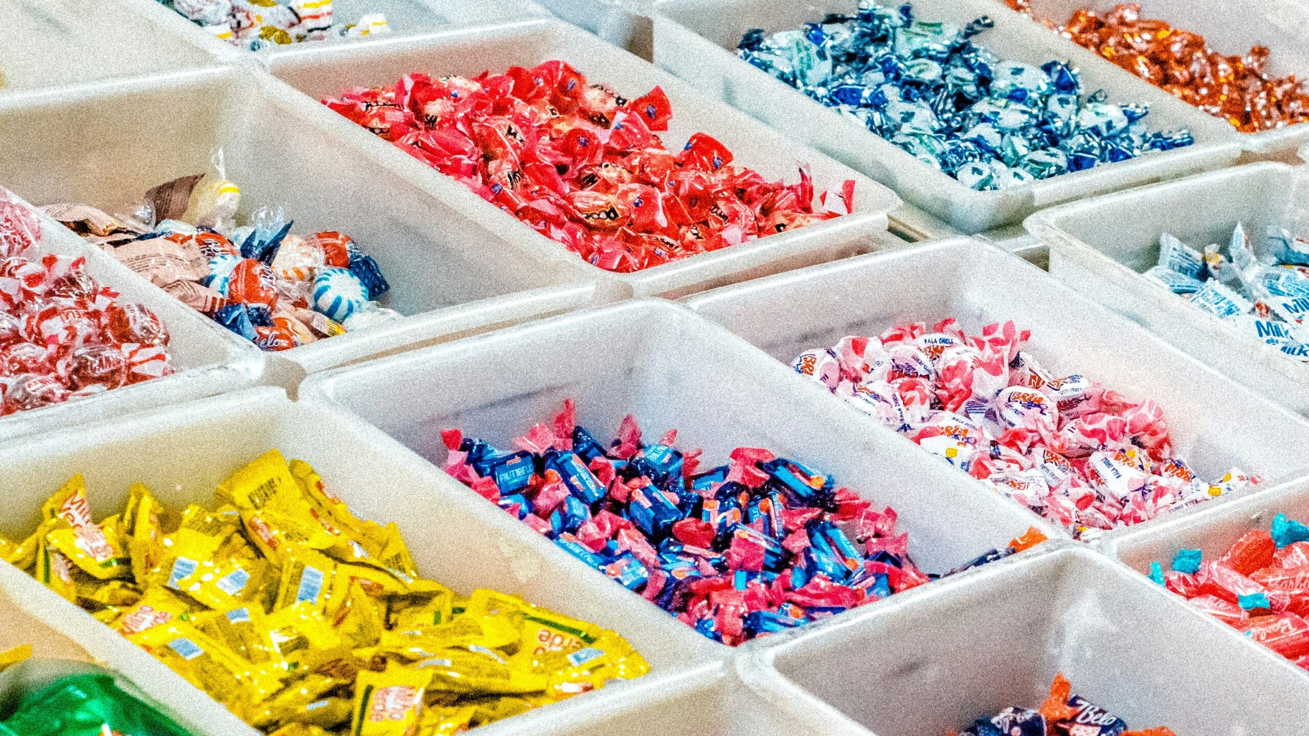 person holding a candy pack on white plastic box