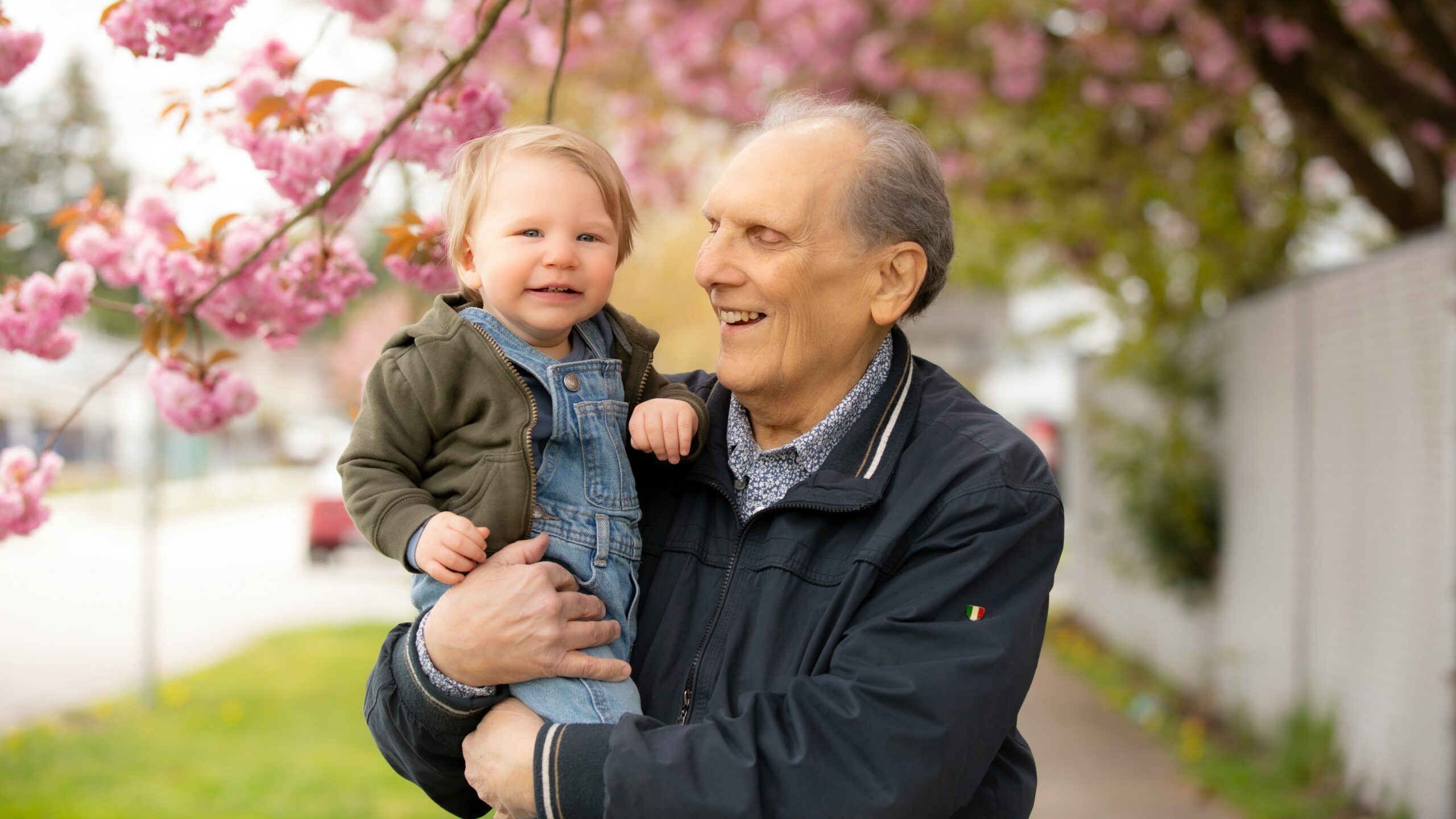 a man holding a little boy in his arms
