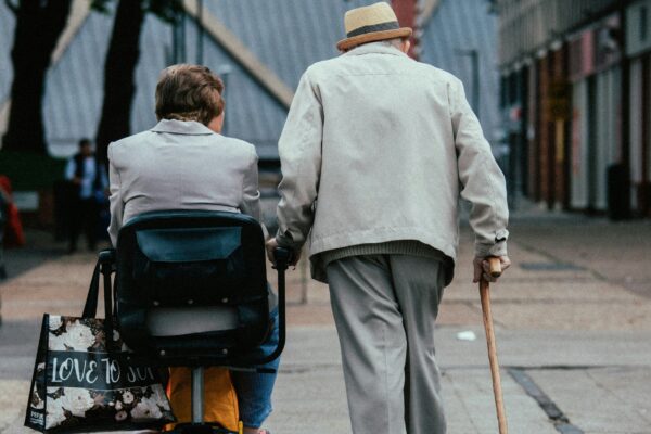 a man pushing a woman in a stroller