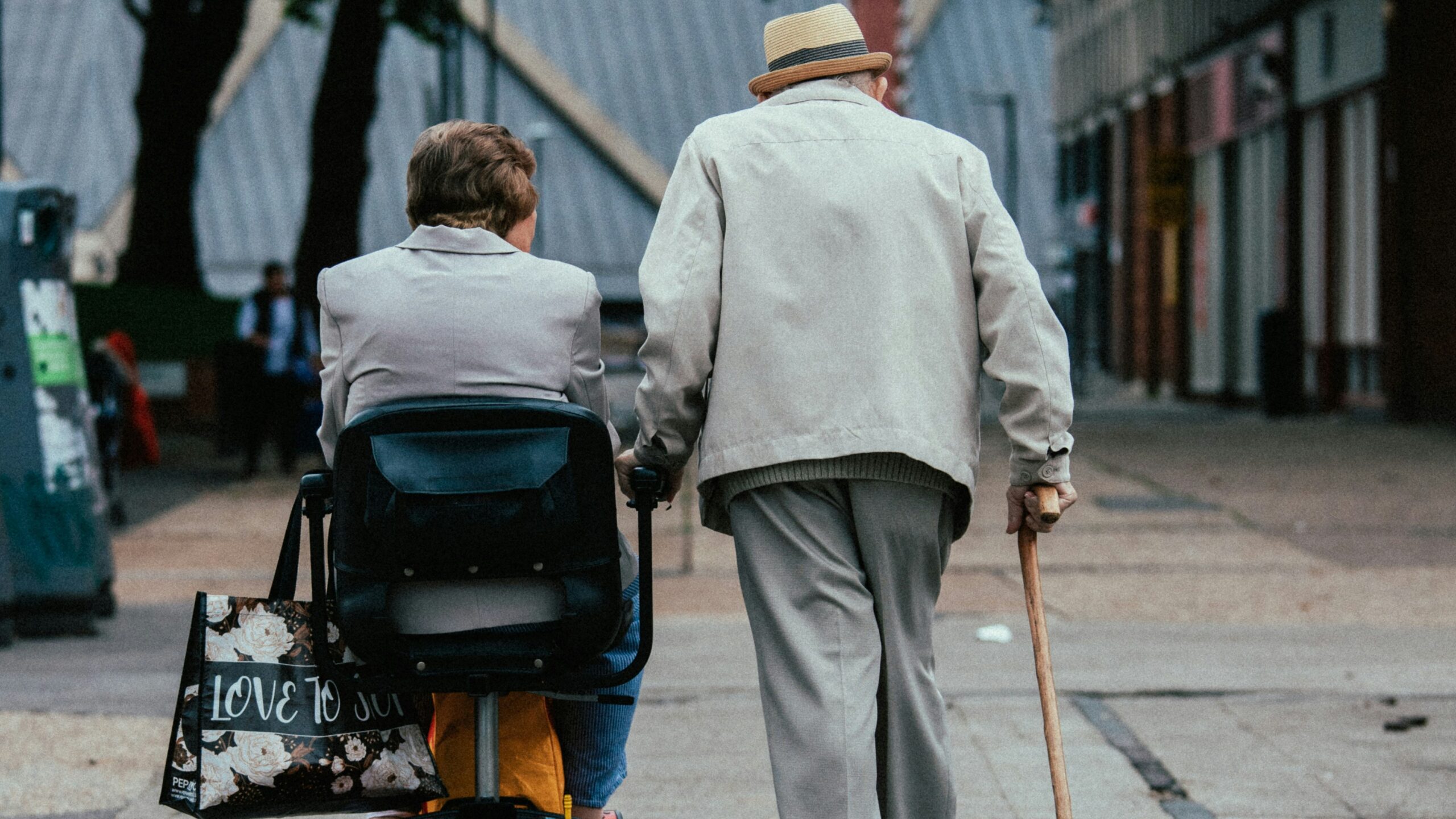 a man pushing a woman in a stroller