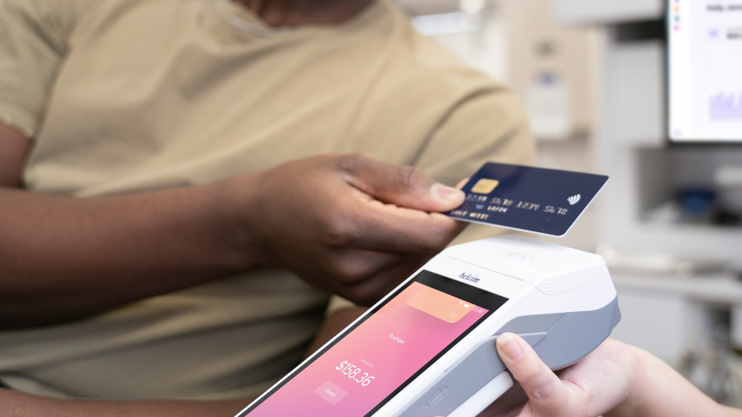 a person holding a credit card and a cell phone