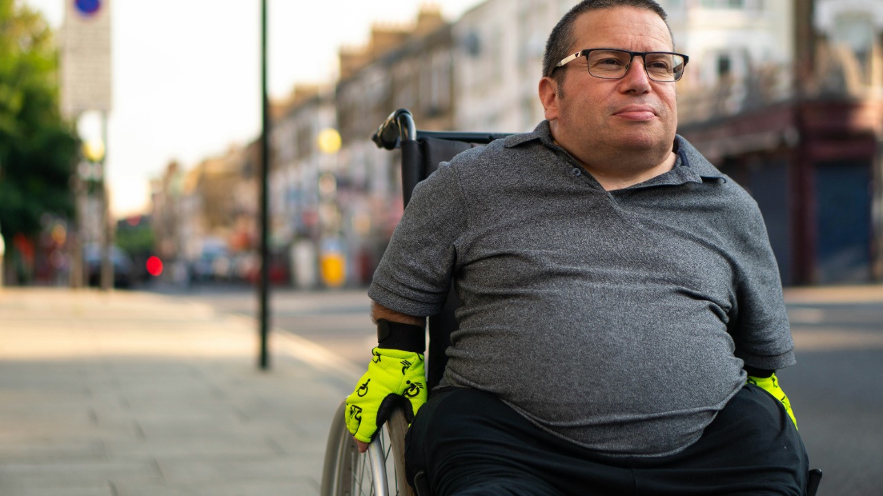 a man in a wheelchair on a city street