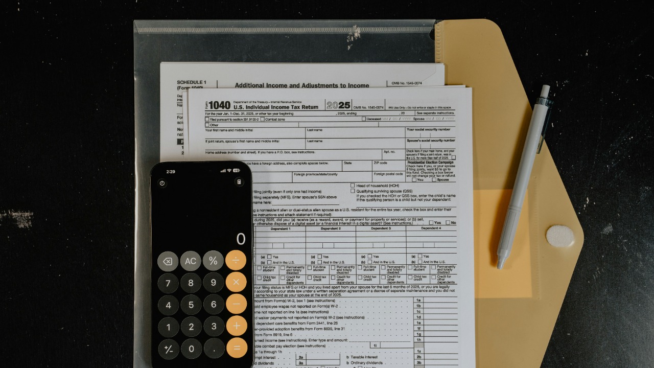 Calculator and pen on tax forms