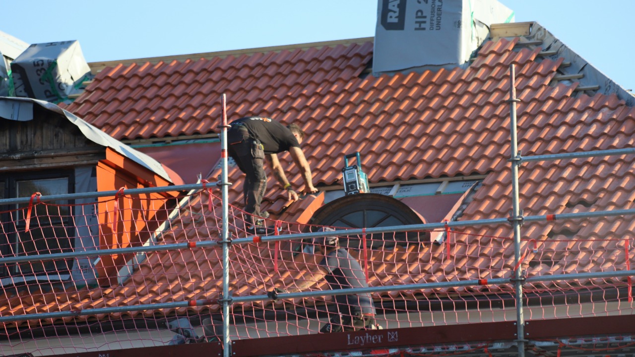 A man on a roof working on a roof