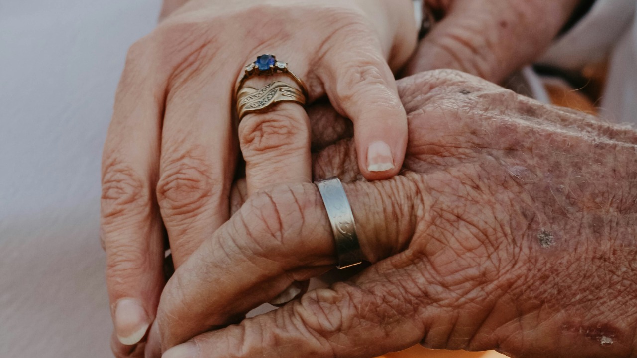 a close up of two people holding hands