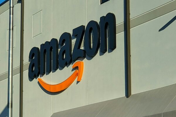 an amazon store with a person sitting in front of it