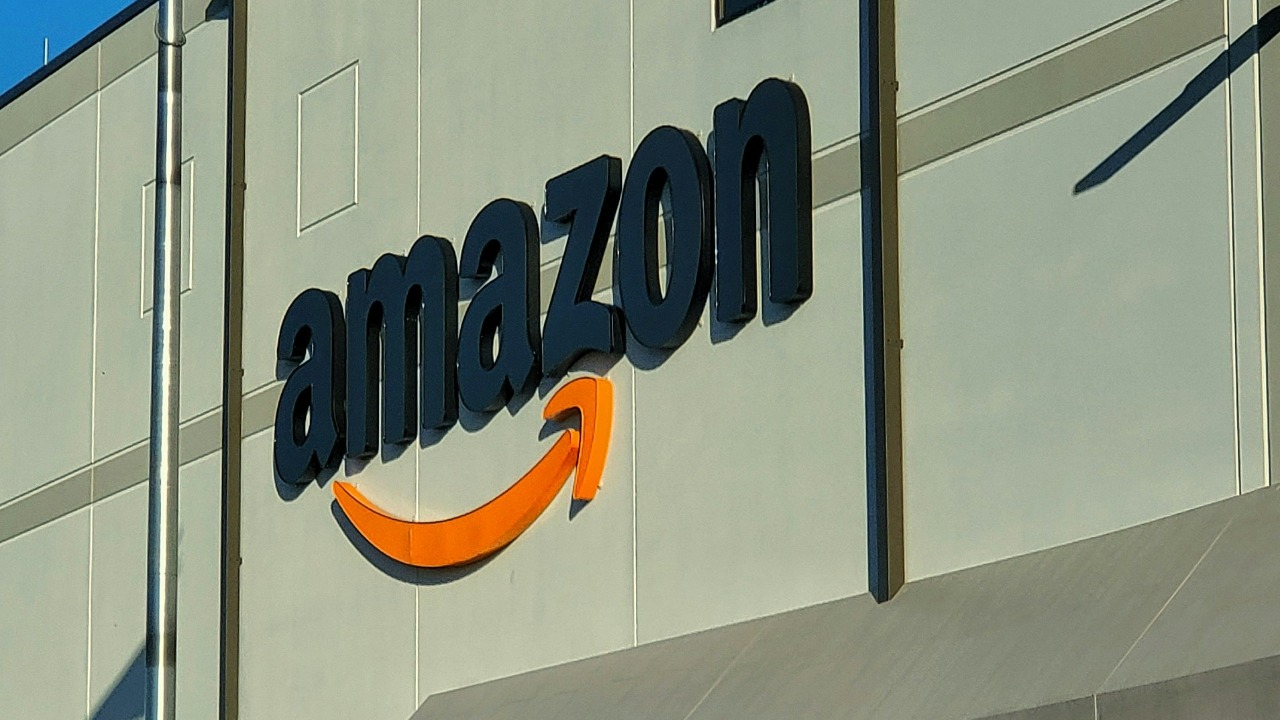 an amazon store with a person sitting in front of it