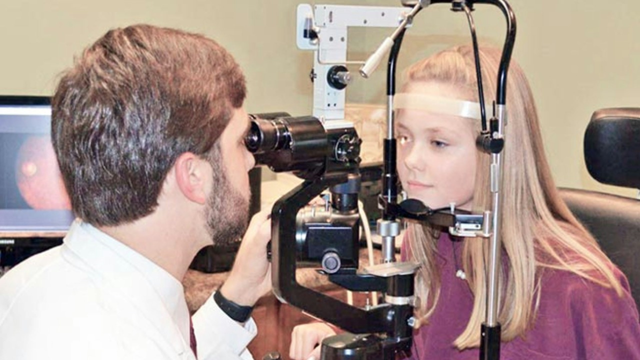 A man and a woman looking through a camera