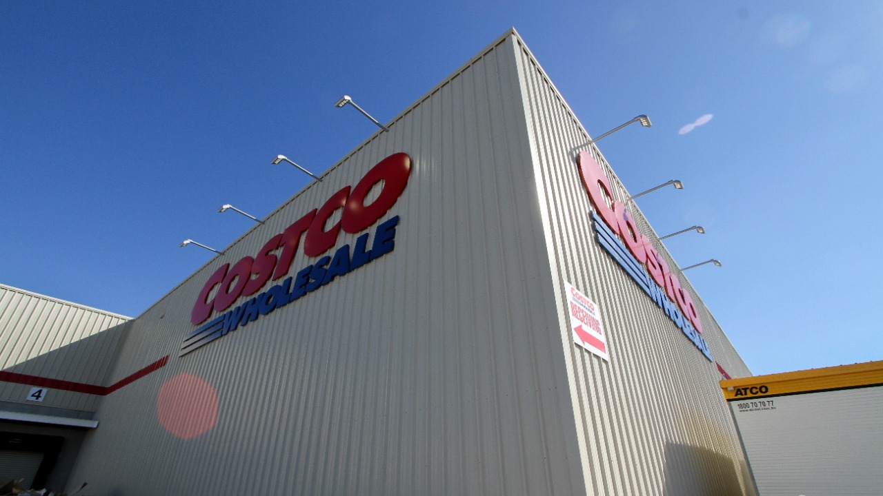 a large white building with a red and blue sign on it