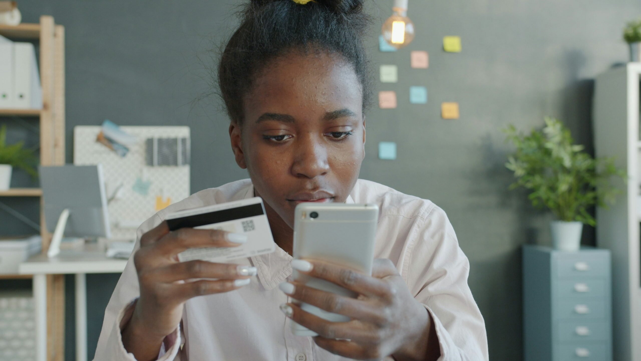 Woman holding credit card and smartphone for online shopping