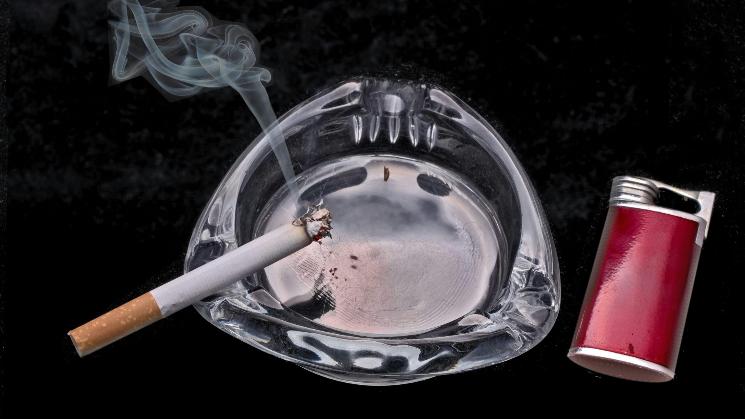 cigarette stick on blue and white ceramic round ashtray
