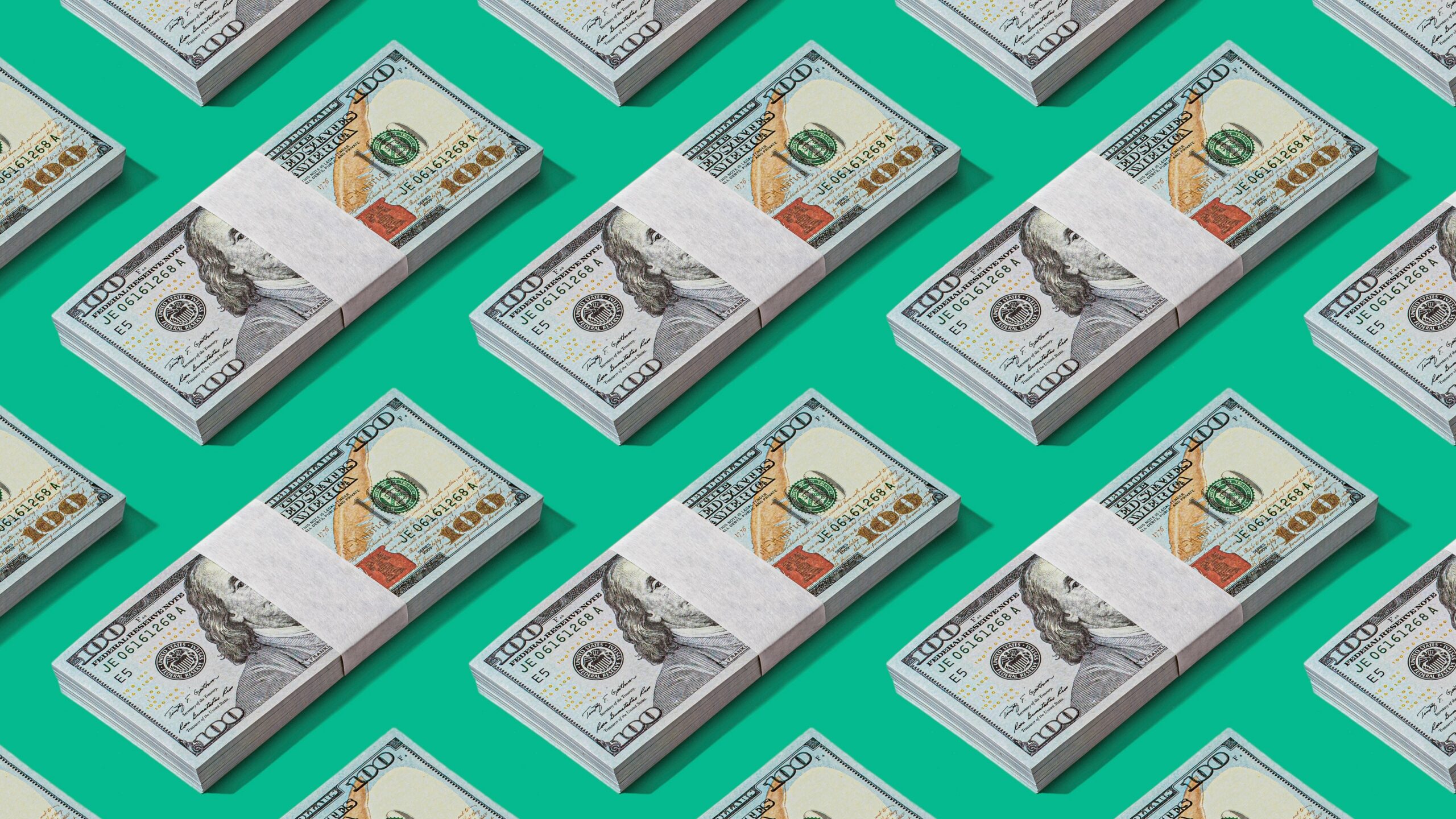 a lot of money sitting on top of a green surface