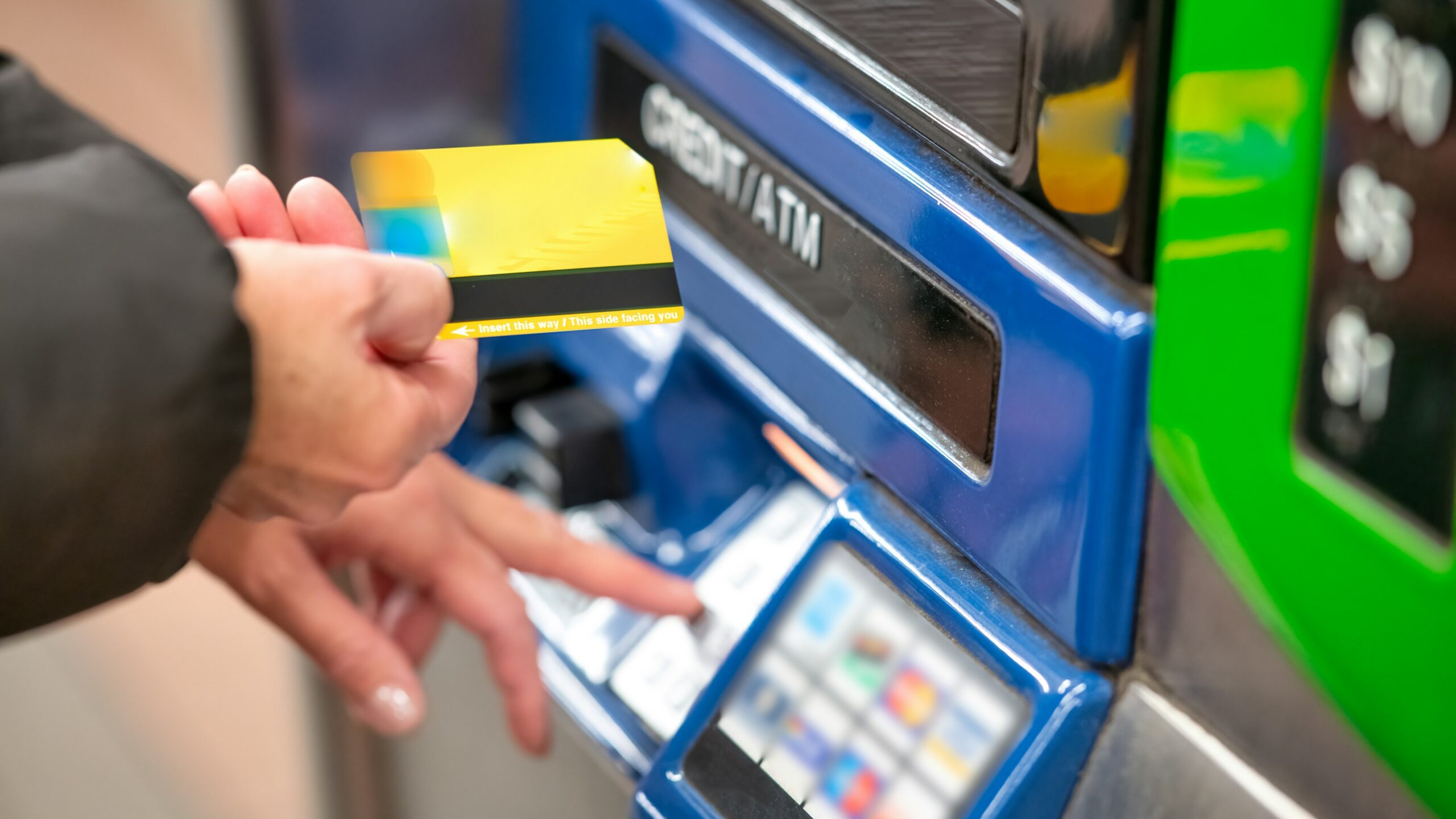 a person using a credit card to pay for a machine