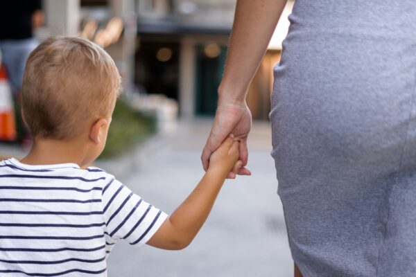 boy and woman holding hands outdoor